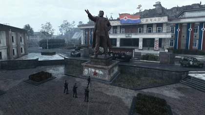 Utility vehicles and a cargo truck passing a statue in official MW4 DMZ footage